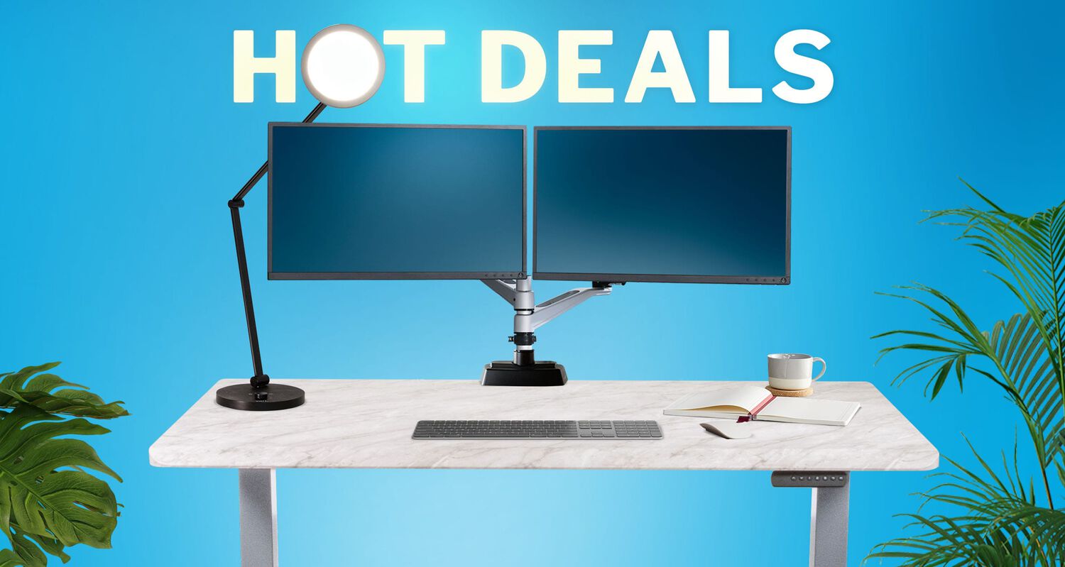 Hot Deals on top of two monitors attached to a standing desk
