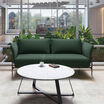 contemporary three-seat sofa in moss geen placed in office setting with the contemporary coffee table