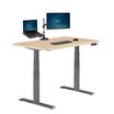 angle view of light wood finish electric standing desk in comfort edge 60x24