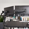 flexible monitor arms with integrated cable system to keep workspace clutter free