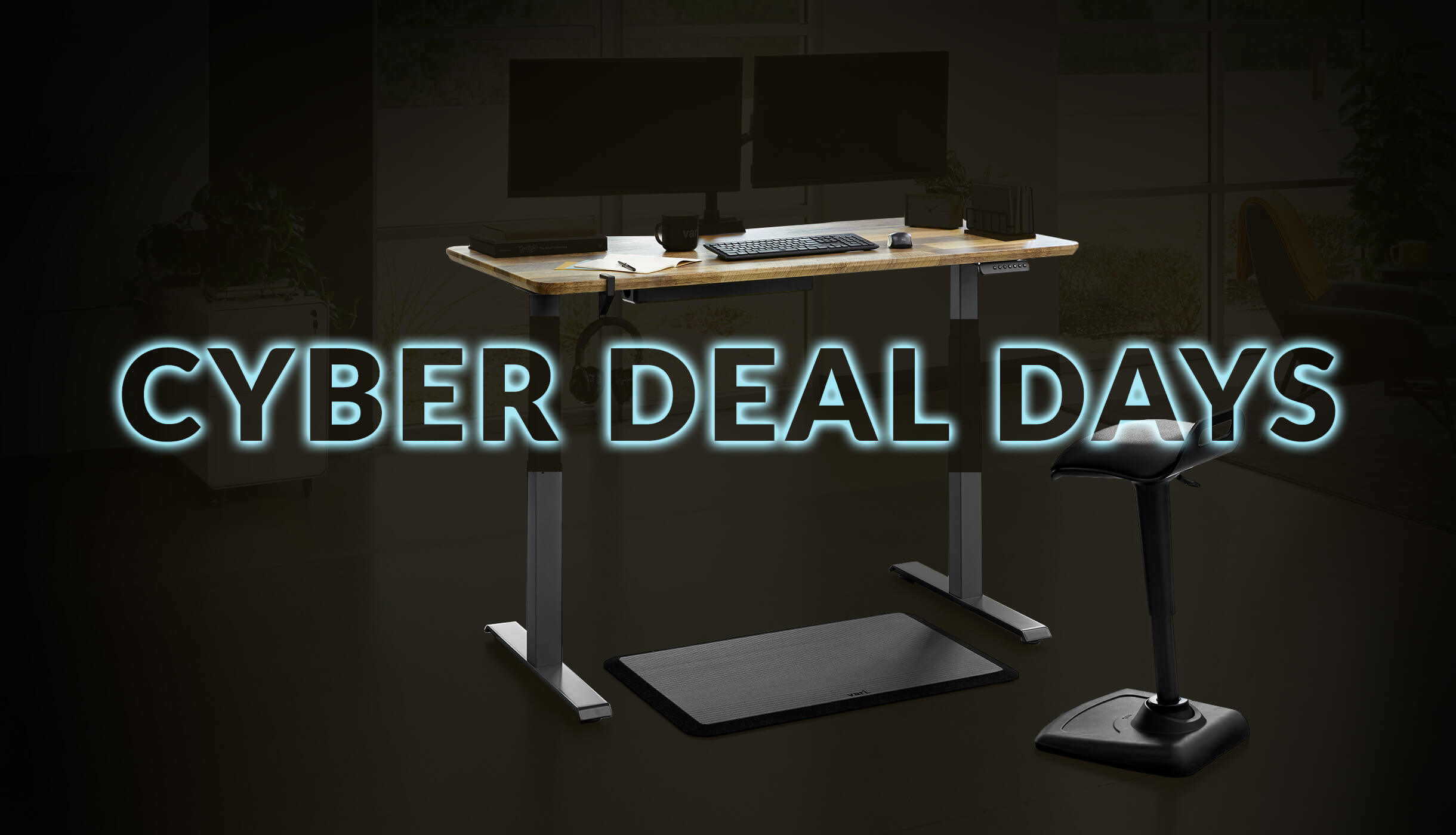 electric standing desk with a stool in front of it cyber deal days